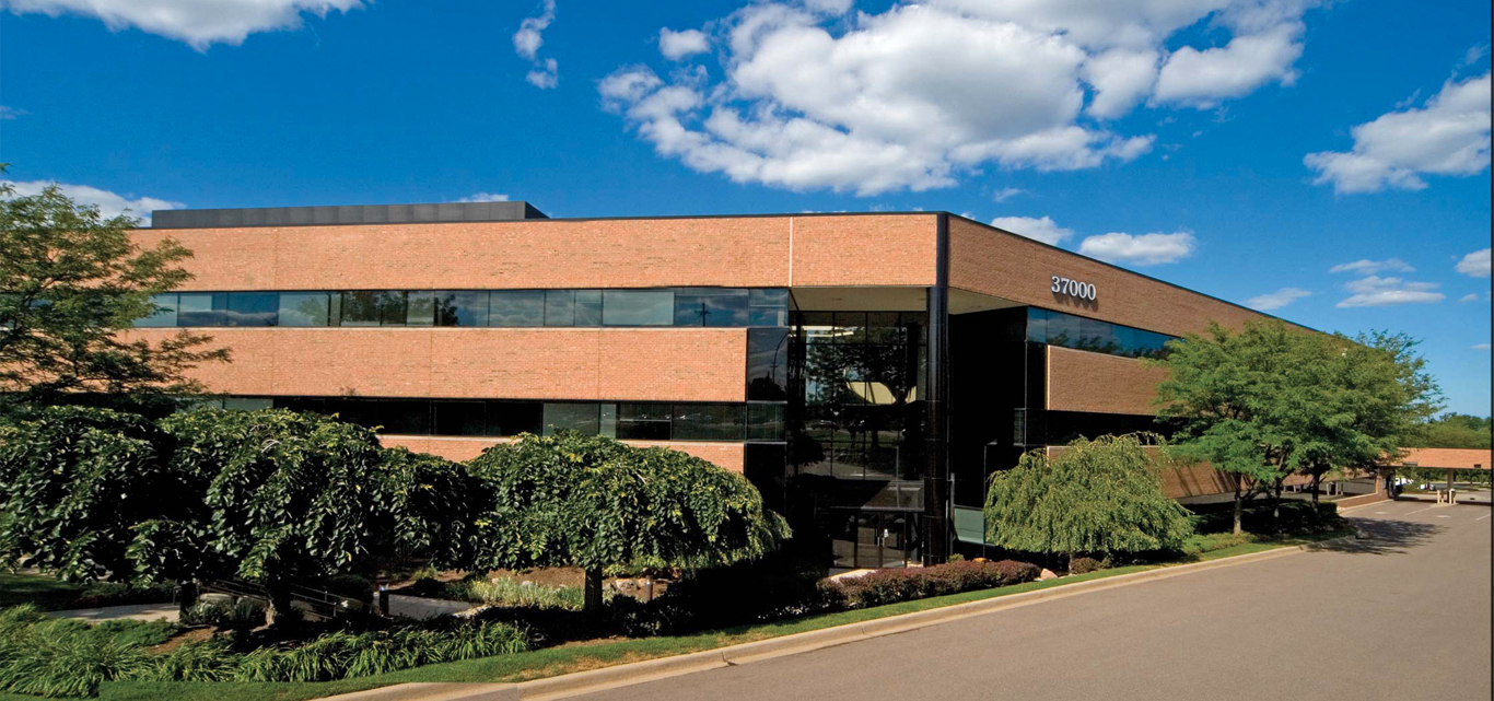 37000 Grand River — exterior, three-quarter view from the parking lot